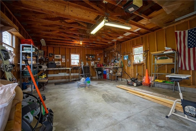 garage featuring a garage door opener and a workshop area