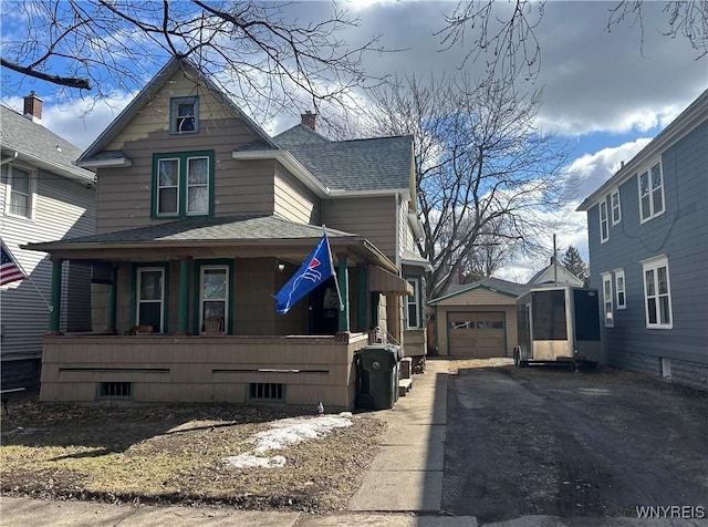 view of side of property featuring a shingled roof, a porch, a garage, driveway, and an outdoor structure