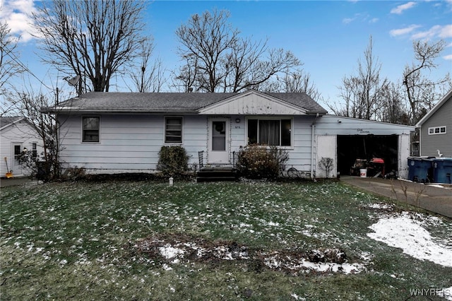 view of front of home with an attached carport, concrete driveway, and a front lawn