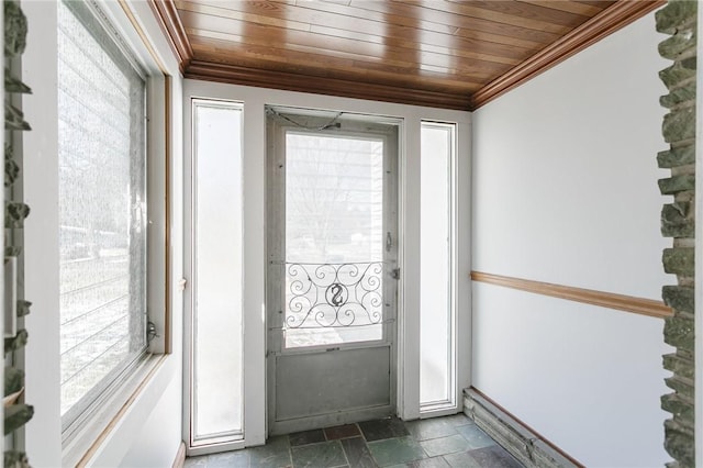 doorway to outside with baseboards, wood ceiling, ornamental molding, and stone tile floors