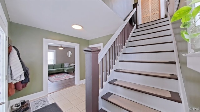 staircase with tile patterned flooring and baseboards