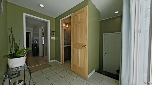 interior space with recessed lighting, baseboards, and light tile patterned flooring