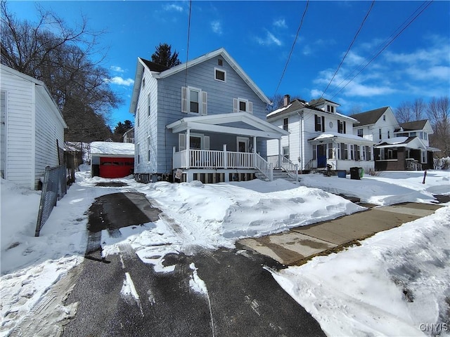 view of front of property featuring a garage and covered porch