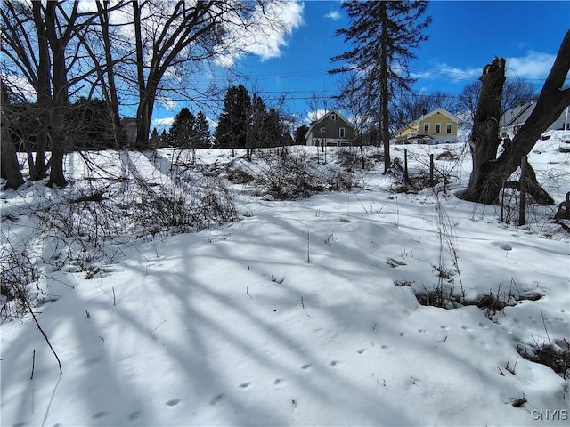 snowy yard with a garage