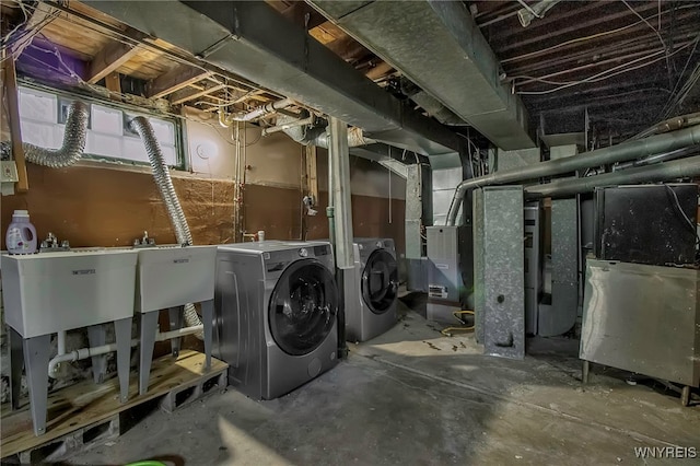 below grade area with a sink and washing machine and clothes dryer