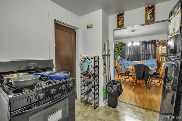 kitchen featuring black appliances and a notable chandelier