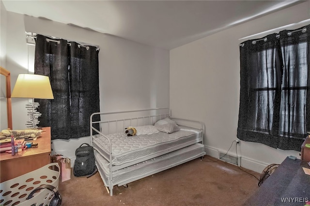 bedroom with carpet and baseboards