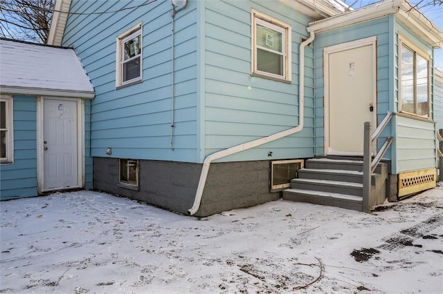 view of snow covered property entrance