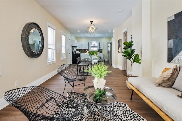 living area featuring dark wood-style floors, baseboards, and recessed lighting