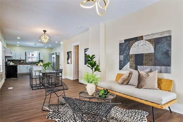 living room featuring dark wood-type flooring and baseboards