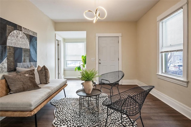 sitting room with dark wood-style floors and baseboards