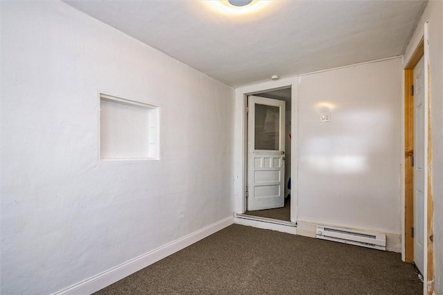 empty room featuring a baseboard radiator, dark carpet, and baseboards