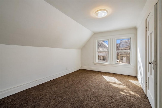 additional living space featuring lofted ceiling, carpet, and baseboards