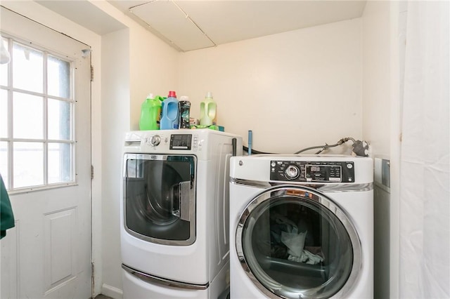 clothes washing area with washing machine and dryer and laundry area