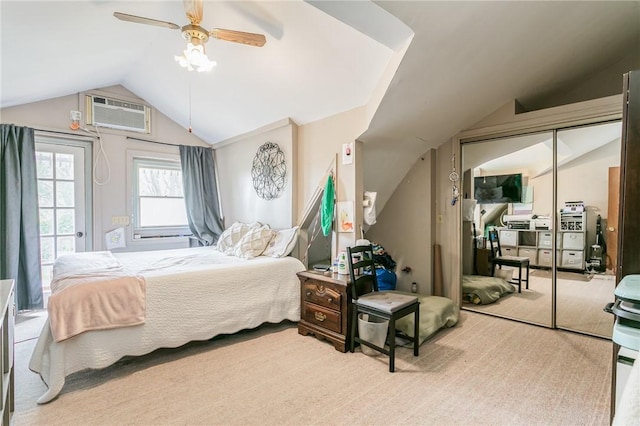 carpeted bedroom featuring vaulted ceiling, ceiling fan, a closet, and a wall mounted AC