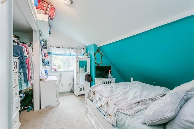 bedroom with vaulted ceiling and carpet flooring