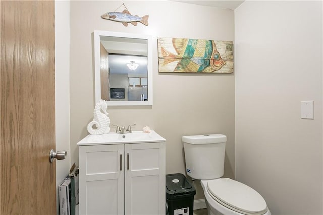 half bathroom with toilet and vanity