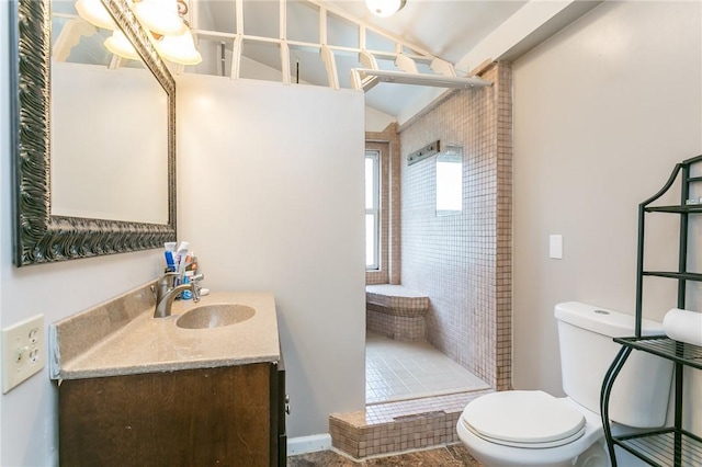 full bathroom featuring lofted ceiling, a shower stall, toilet, and vanity