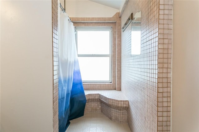 bathroom featuring a shower with curtain and vaulted ceiling