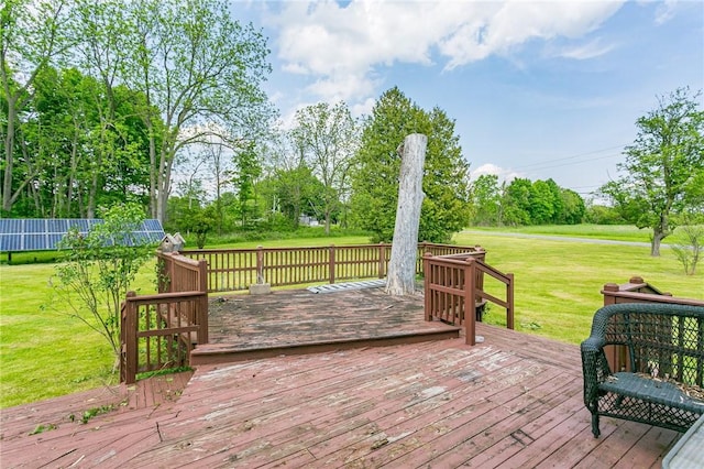 wooden terrace featuring a lawn