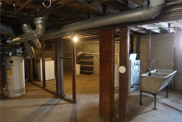 unfinished basement featuring a sink, gas water heater, and washer / clothes dryer