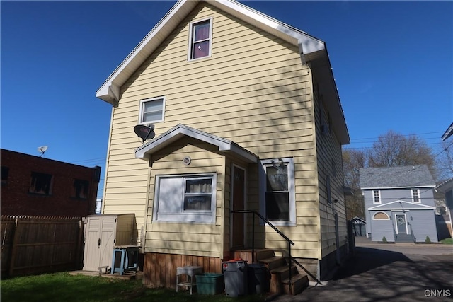 back of house with fence