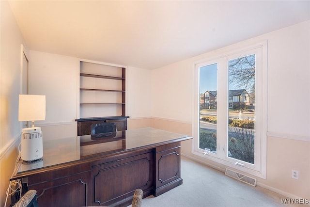 office space featuring visible vents and light carpet