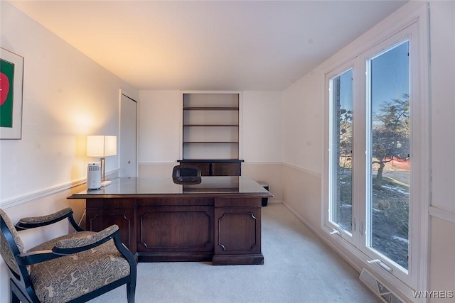 office space featuring visible vents, a wealth of natural light, and light colored carpet