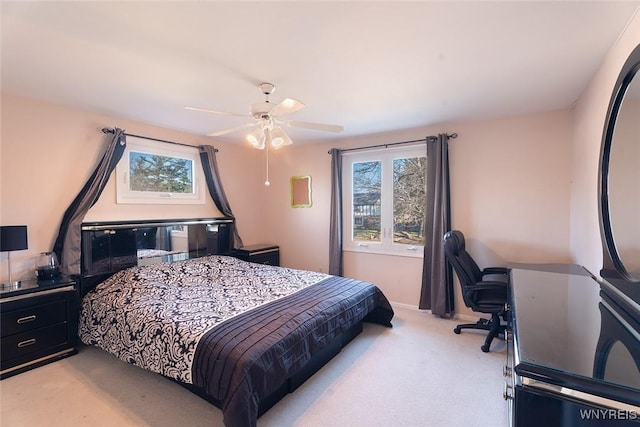 bedroom featuring light carpet and a ceiling fan