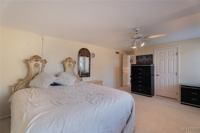 bedroom featuring a ceiling fan and light colored carpet