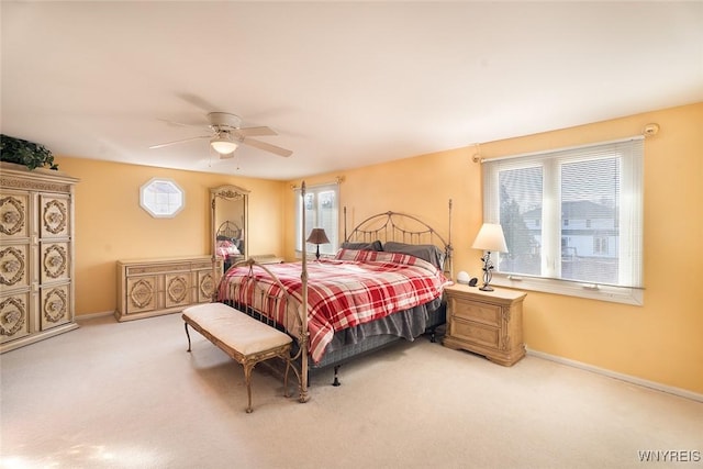 bedroom with ceiling fan, carpet, and baseboards