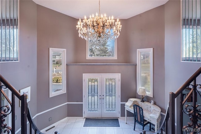 tiled foyer featuring an inviting chandelier, visible vents, stairway, and french doors