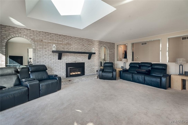 living room featuring carpet, visible vents, a fireplace, and brick wall