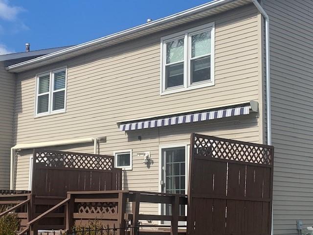 rear view of property with fence