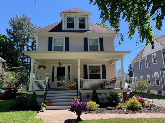 american foursquare style home with a porch