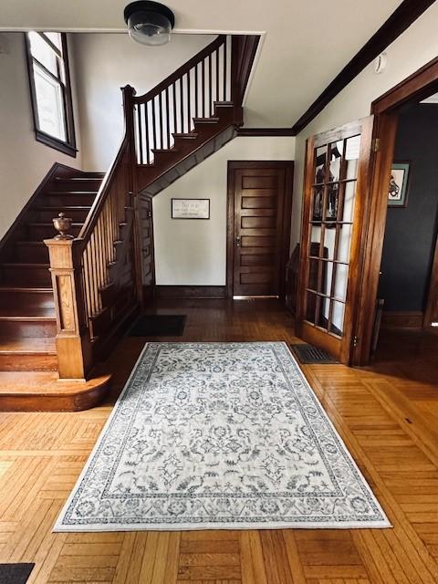 foyer with stairs and ornamental molding