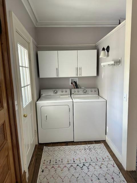 laundry room with baseboards, dark wood finished floors, ornamental molding, washer and dryer, and cabinet space