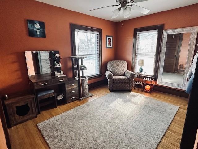 sitting room featuring ceiling fan and wood finished floors