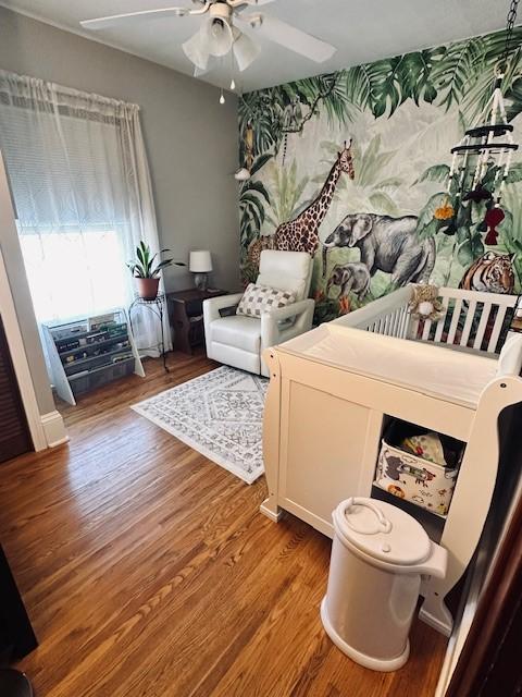 bedroom with ceiling fan and wood finished floors