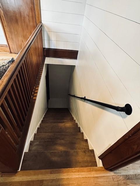 stairway with wood finished floors