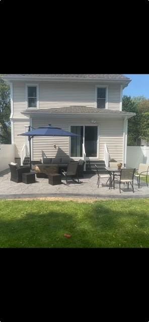 back of house with entry steps and a patio area