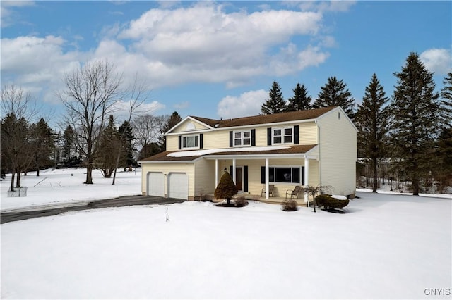 traditional-style home with a porch and aphalt driveway