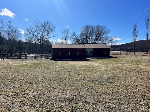 view of outbuilding featuring fence