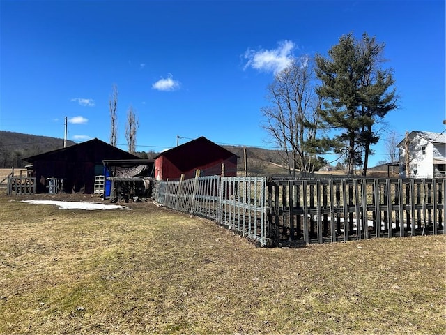 exterior space with an outbuilding and fence