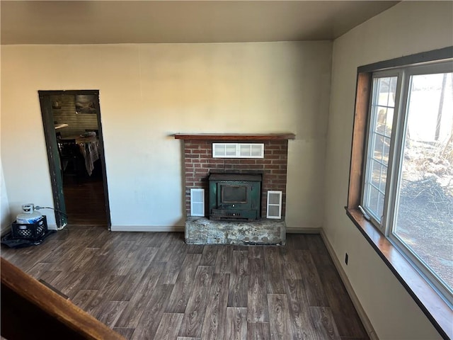 unfurnished living room with visible vents, baseboards, and dark wood-style flooring