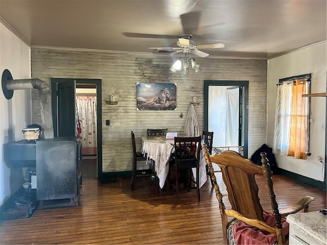 dining area featuring ornamental molding, a ceiling fan, and wood finished floors