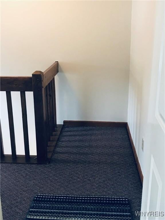 staircase with baseboards and carpet