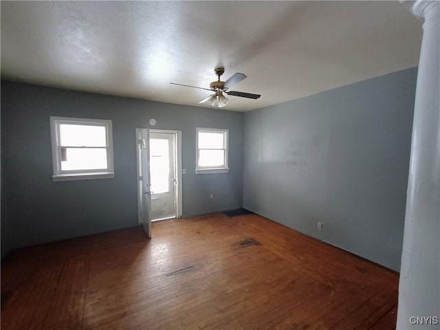 spare room featuring a ceiling fan and hardwood / wood-style flooring