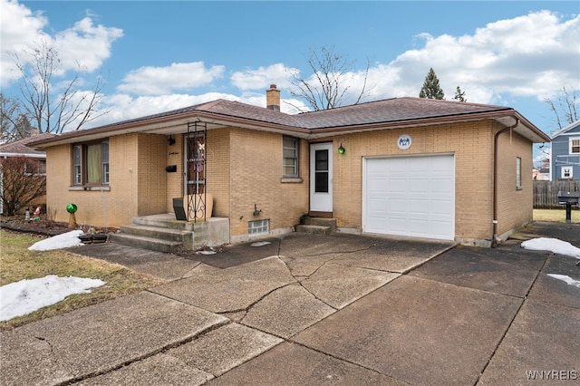 single story home with brick siding, a chimney, concrete driveway, and an attached garage