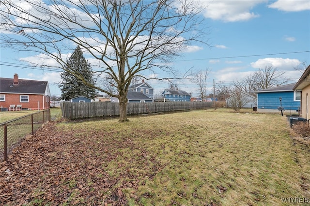 view of yard featuring a fenced backyard and a residential view